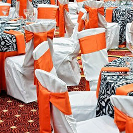 White Chair Covers with Orange Bows